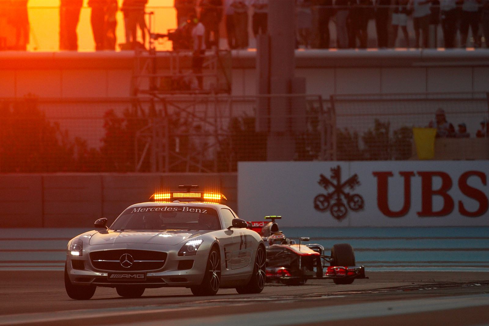 Bernd Maylaender in the safety car leads the field with McLaren's Hamilton still in front whilst the track is cleaned after an accident