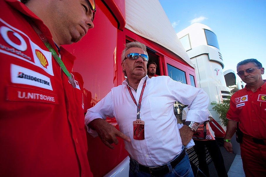 Schumacher's manager Willi Weber bracing the Ferrari motorhome