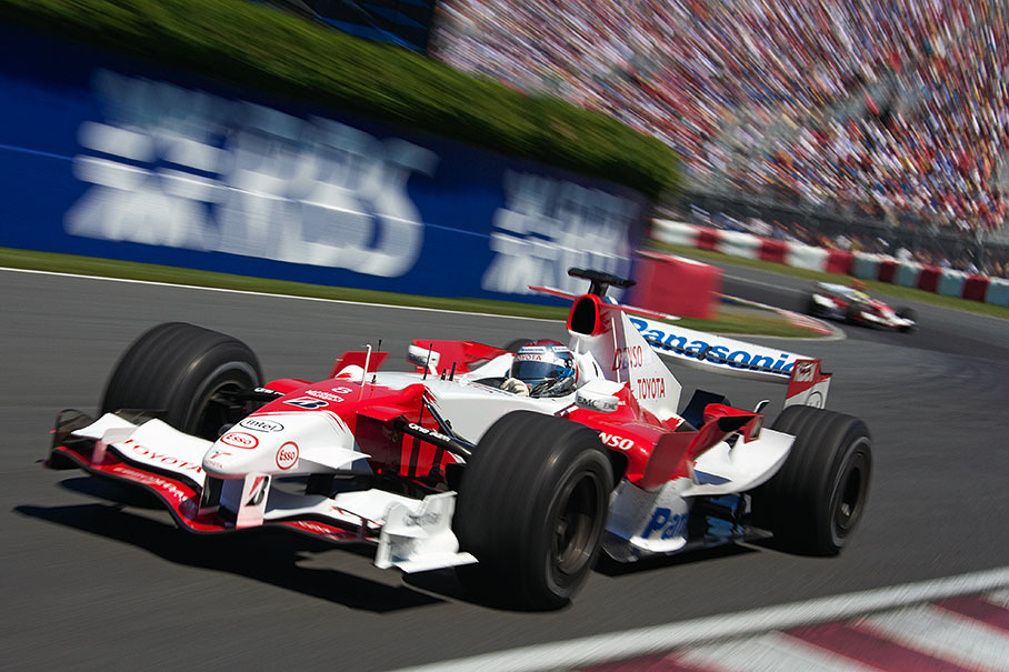 Jarno Trulli pulling his Toyota teammate through a flash of F1 colours