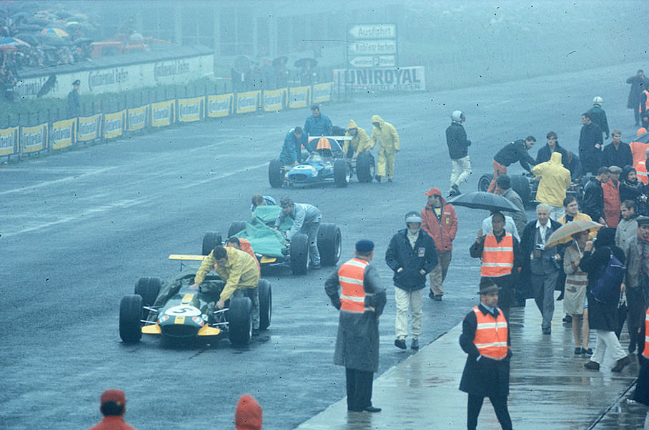 The two Brabham-Repco BT26 are being pushed to a rainy grid