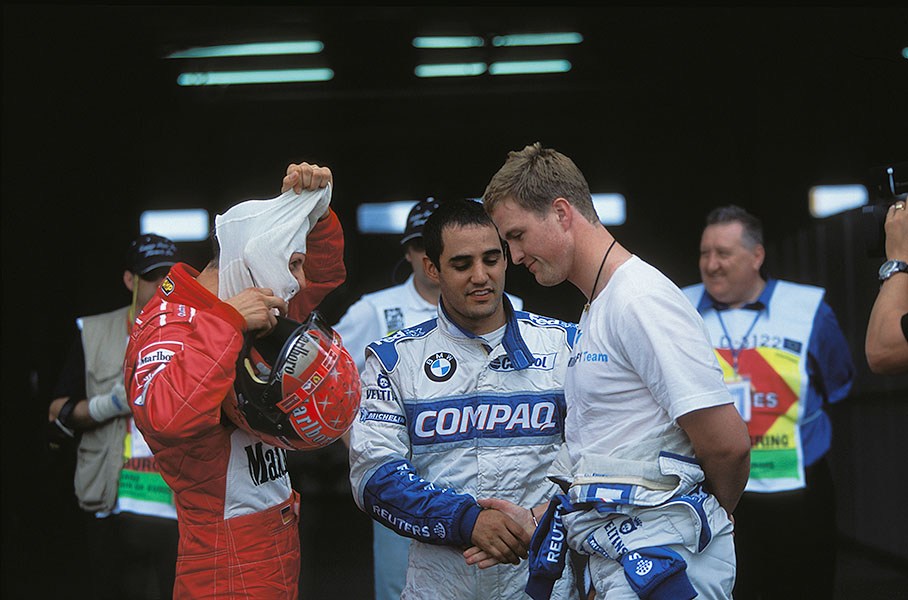 Friends forever? Williams-BMW drivers Montoya and Ralf Schumacher shake hands after reserving the grid's front row for their team at the 2002 European GP