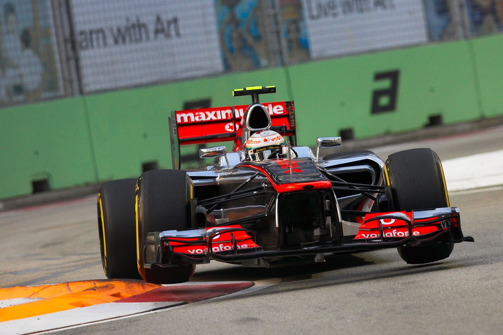 Lewis Hamilton, McLaren Mercedes, jumps over the curbs