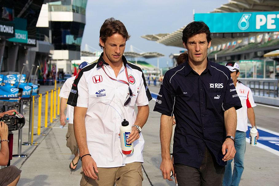 Jenson Button and Mark Webber walking through the pitlane