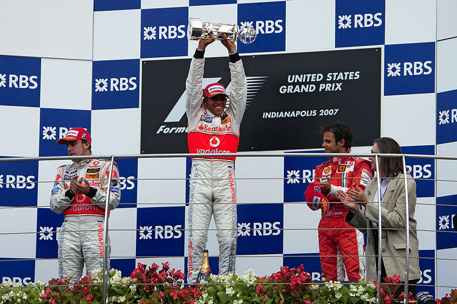 Lewis Hamilton proudly raises his trophy