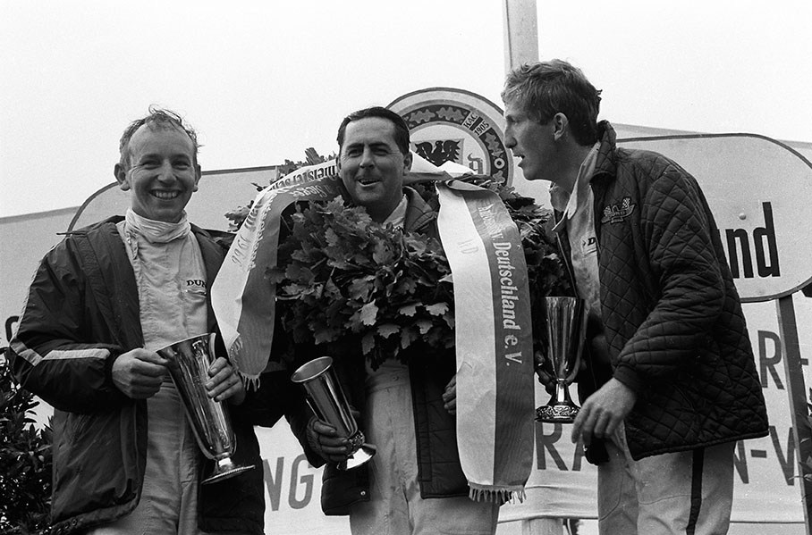 Fun on the podium for winner Jack Brabham, second placed John Surtees and third placed Jochen Rindt