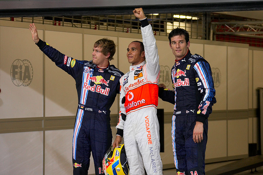 The fastest three qualifiers pose together for the world's media: second qualified Sebastian Vettel, Hamilton as polesetter in the middle and Mark Webber as third on the grid