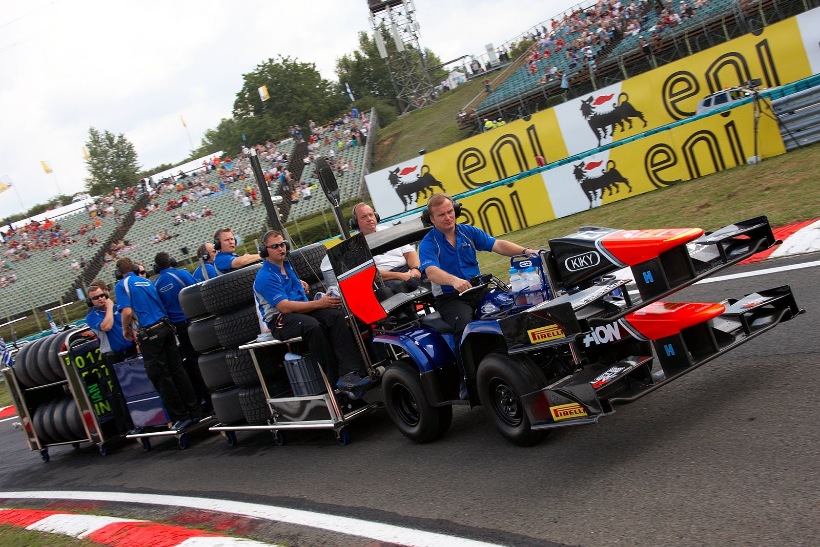 The GP2 mechanics drag their equipment to pitlane