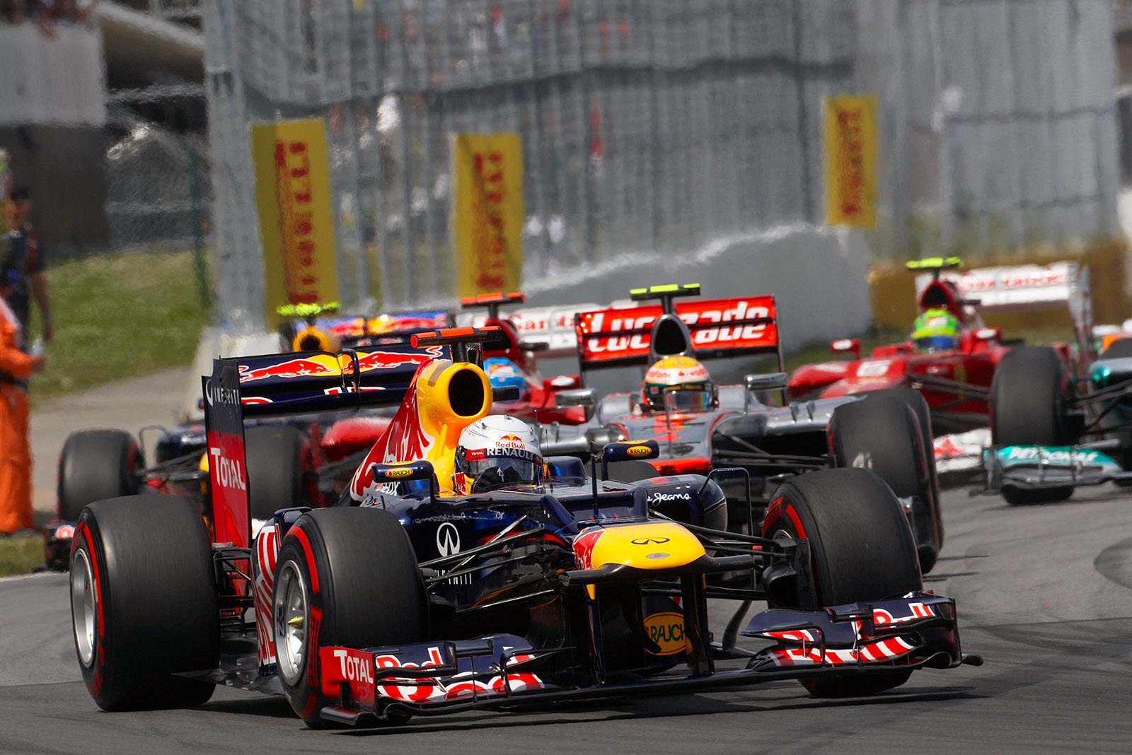 The start field enters a close turn with Vettel in the lead, followed by Hamilton and Alonso
