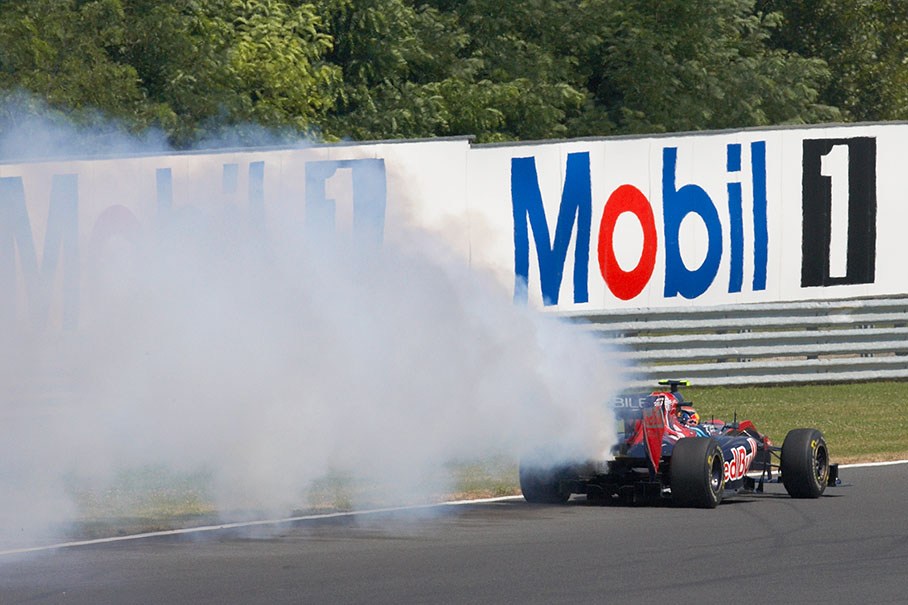 Jaime Alguersuari with smoke coming from his Toro Rosso-Ferrari car