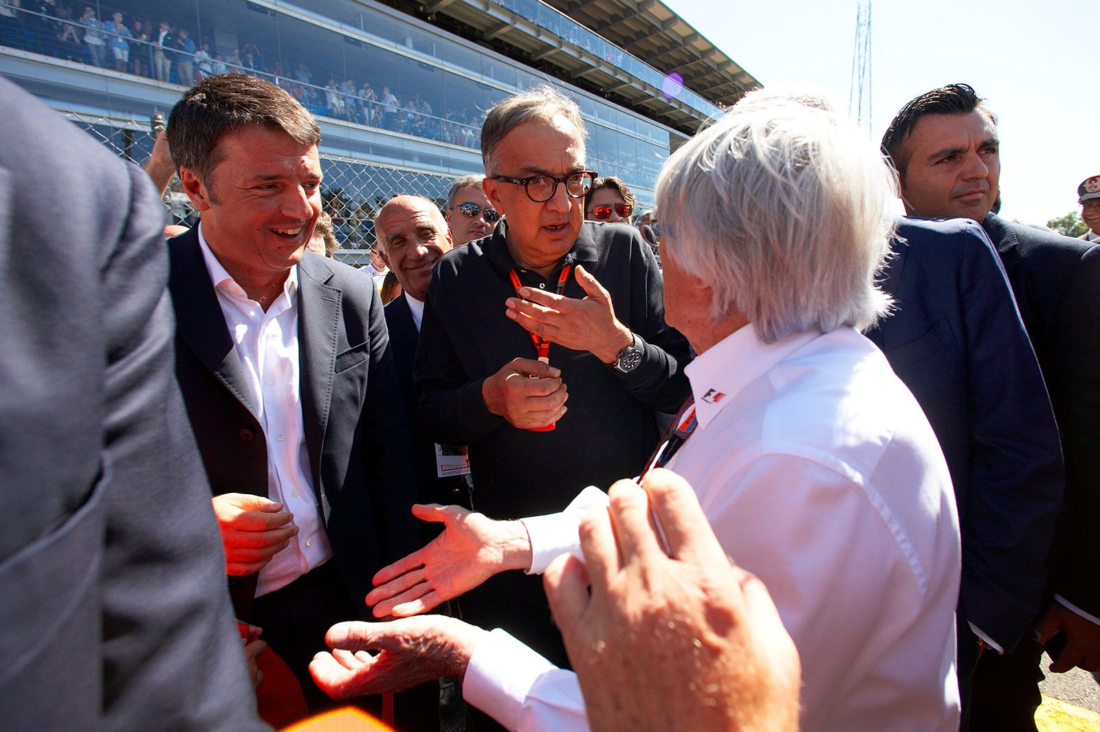 Young Italian prime minister Matteo Renzi and Sergio Marchionne, chairman of Ferrari, meet up with Bernie Ecclestone, Italian Grand Prix, Monza, 2015