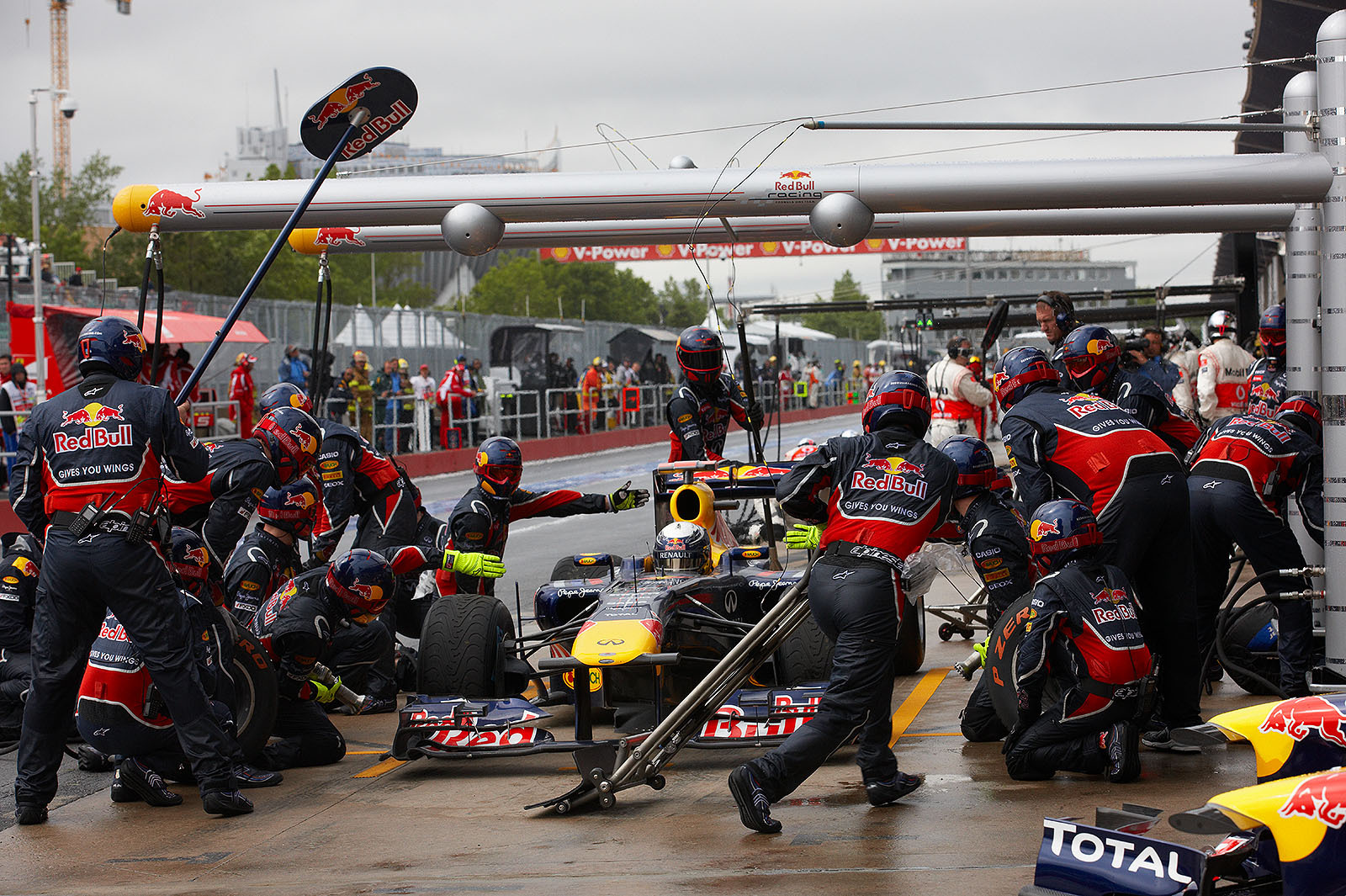 Sebastian Vettel changes from wet to intermediate tyres at Red Bull pits