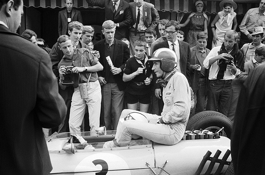 After retiring on lap 13 with engine problems, Swiss driver Jo Siffert comes back to the pits at the end of the race, sitting at the back of Ireland's BRP