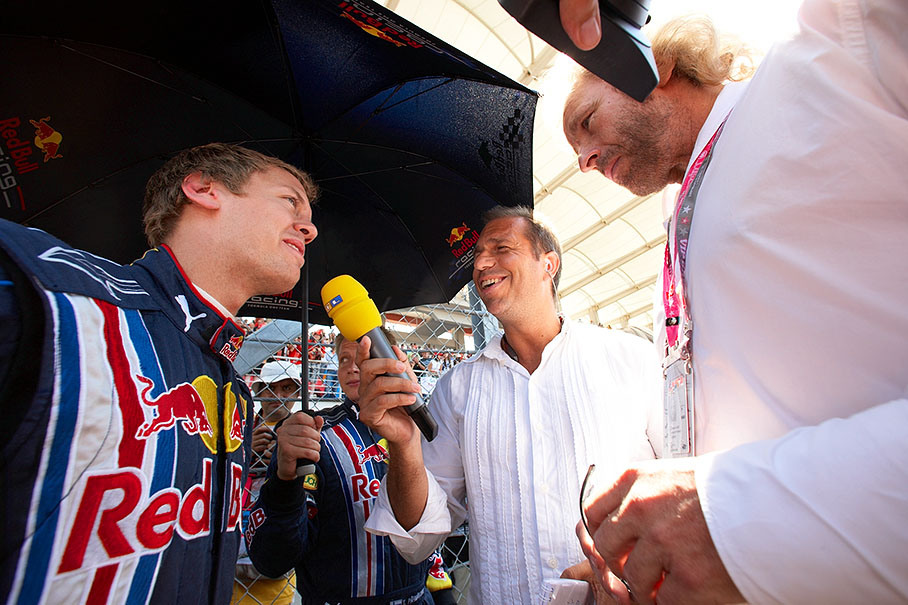 Sebastian Vettel talks to TV presenter Kai Ebel and entertainer Thomas Gottschalk on the grid