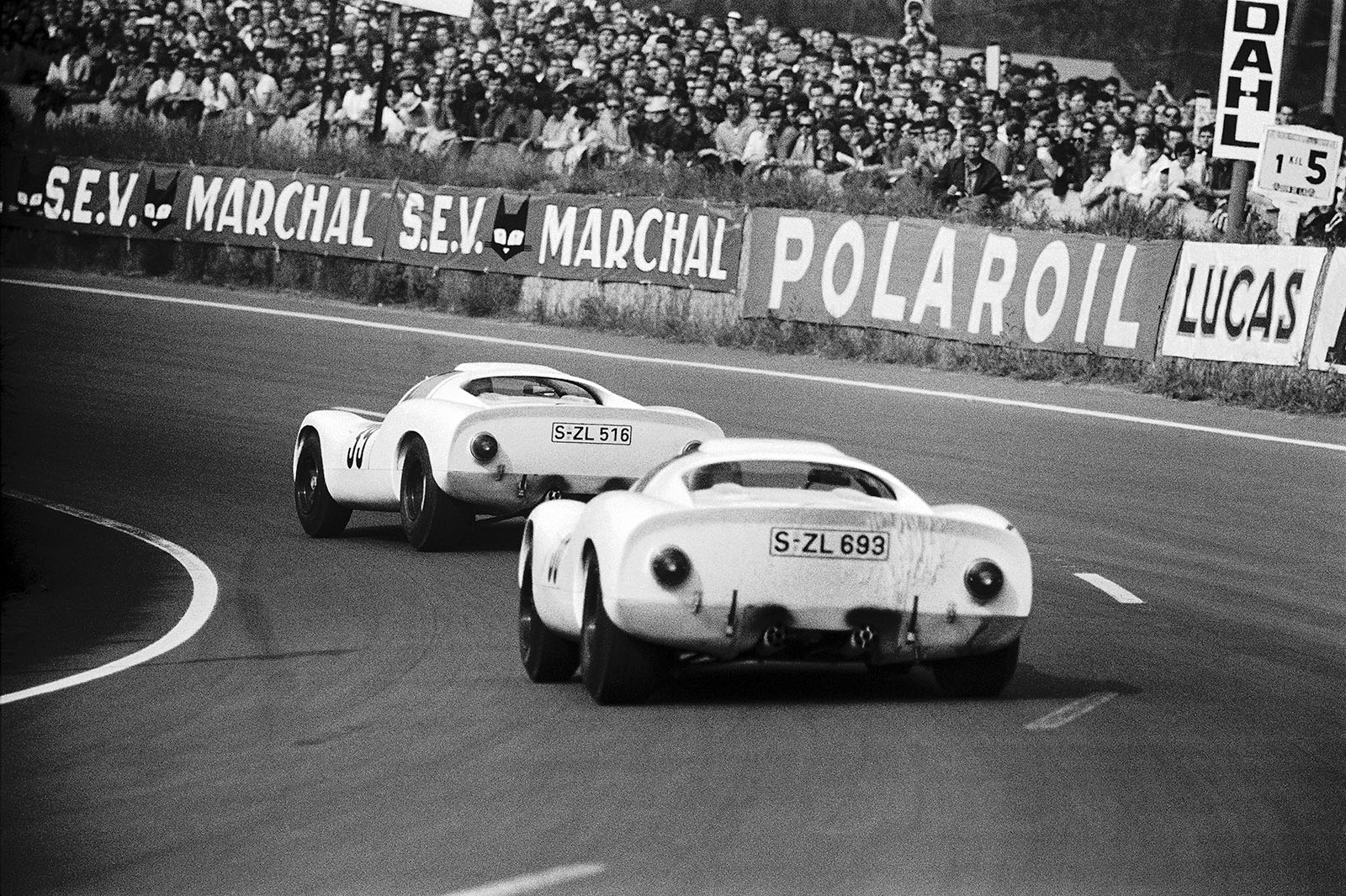 Rolf Stommelen (D) and Jochen Neerpasch (D) on Porsche 910 016 S-ZL 693 close behind their colleagues in the other 910