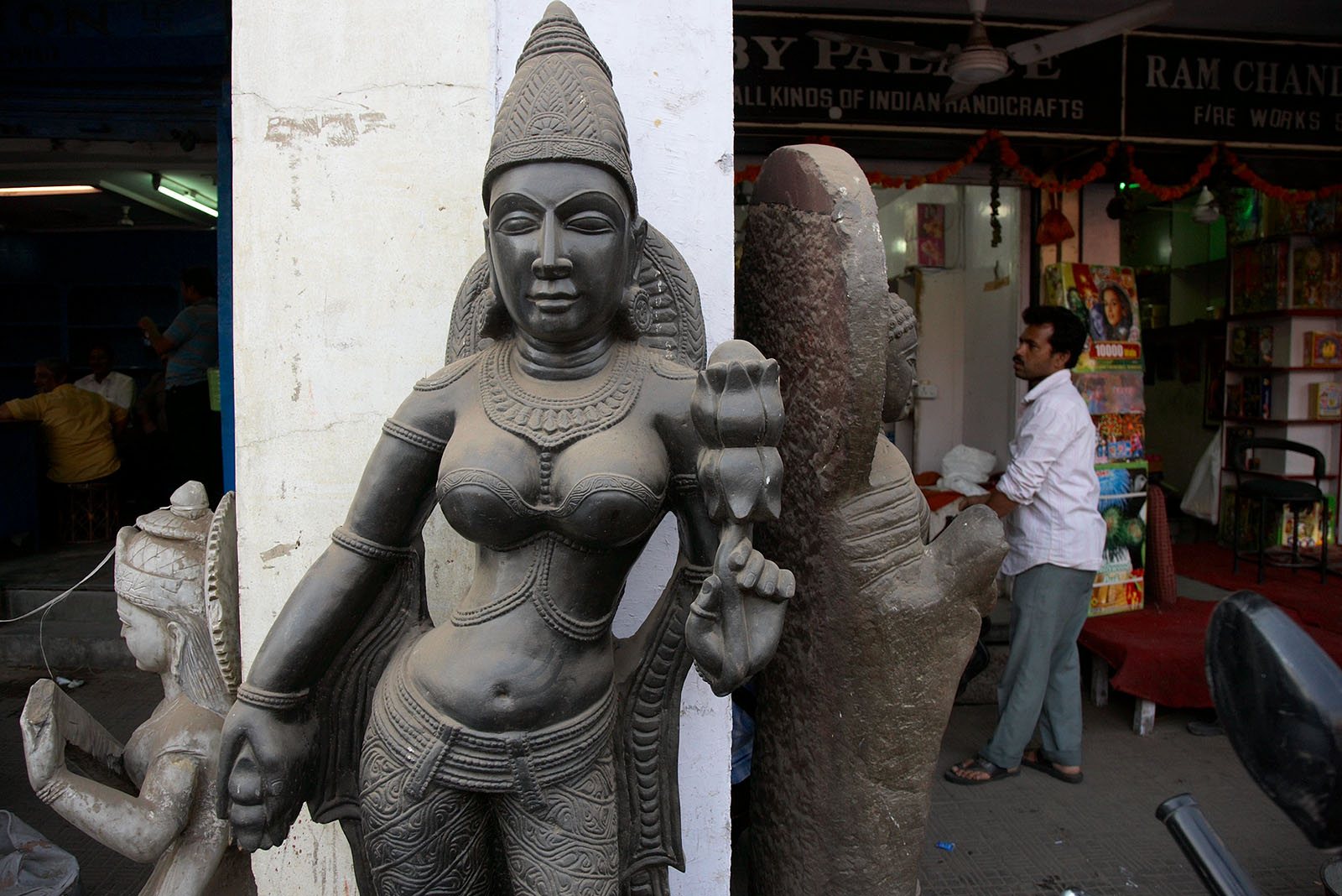A statue of a serious looking Indian goddess