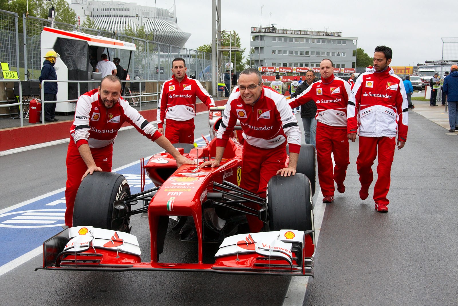 Motivated Ferrari mechanics push their race car to scrutineering