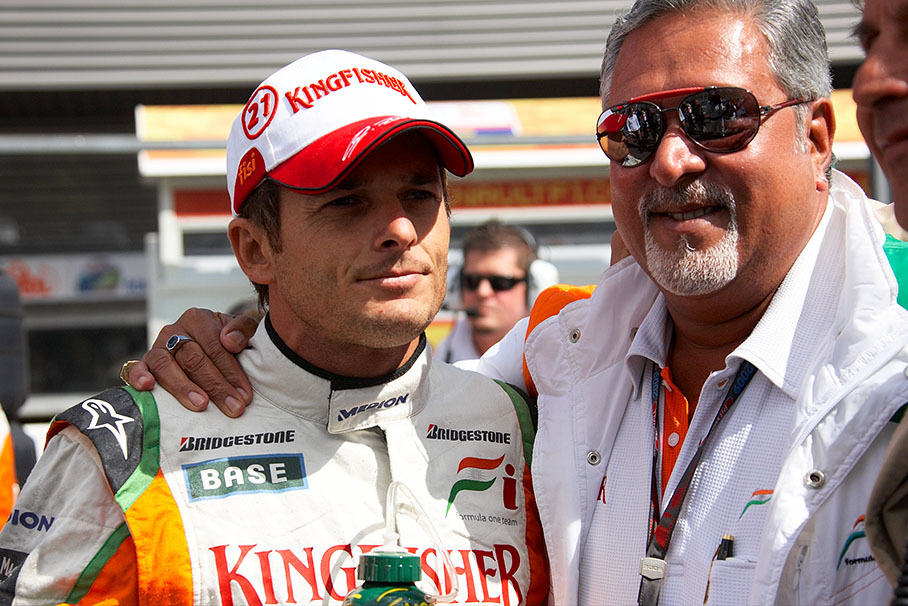 Force India Team owner Dr. Vijay Mallya caresses his polesetter Giancarlo Fisichella before the race