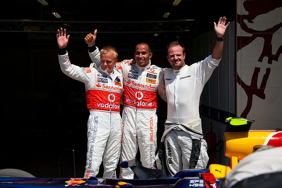 The fastest three qualifiers pose for the media after qualifying in parc ferme: Second positioned Heikki Kovalainen of McLaren Mercedes, his team mate and polesitter Lewis Hamilton and third grid placed Rubens Barrichello of Brawn GP