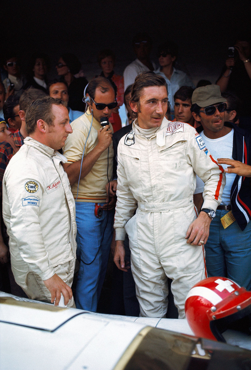 Race winners Jo Siffert and Kurt Ahrens are being interviewed at the pits&#13;behind their Porsche 917 009