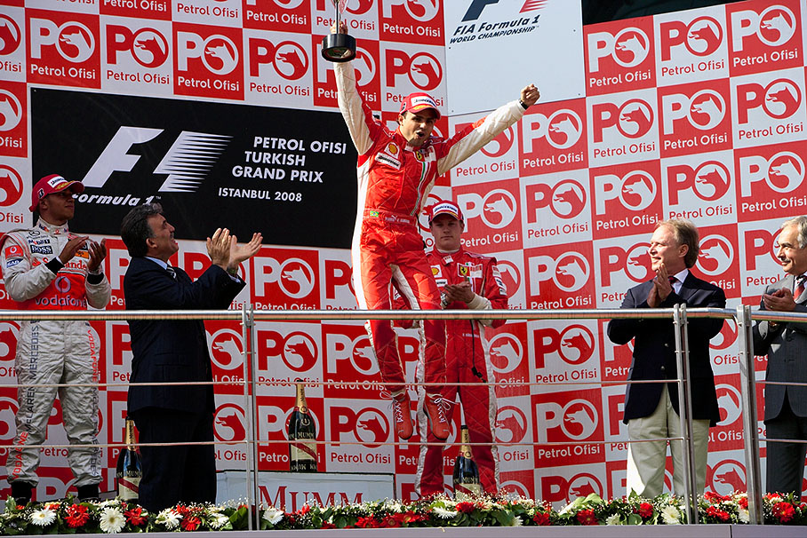 Winner Felipe Massa jumps from the podium