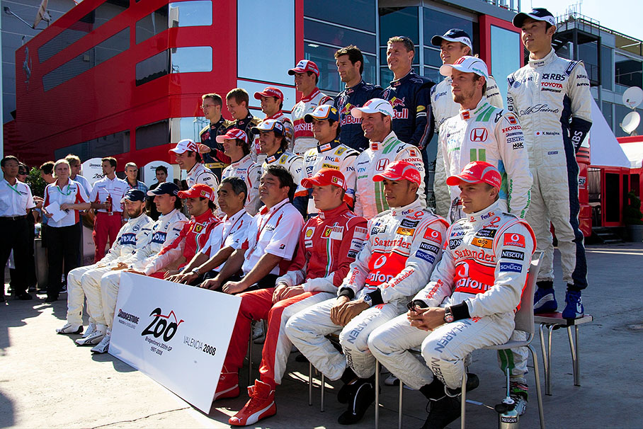 Bridgestone celebrates the company's 200th supplied Grand Prix with a drivers group photo together with motorsport director Hiroshi Yasukawa and Hirohide Hamashida, director of motorsport tyre development