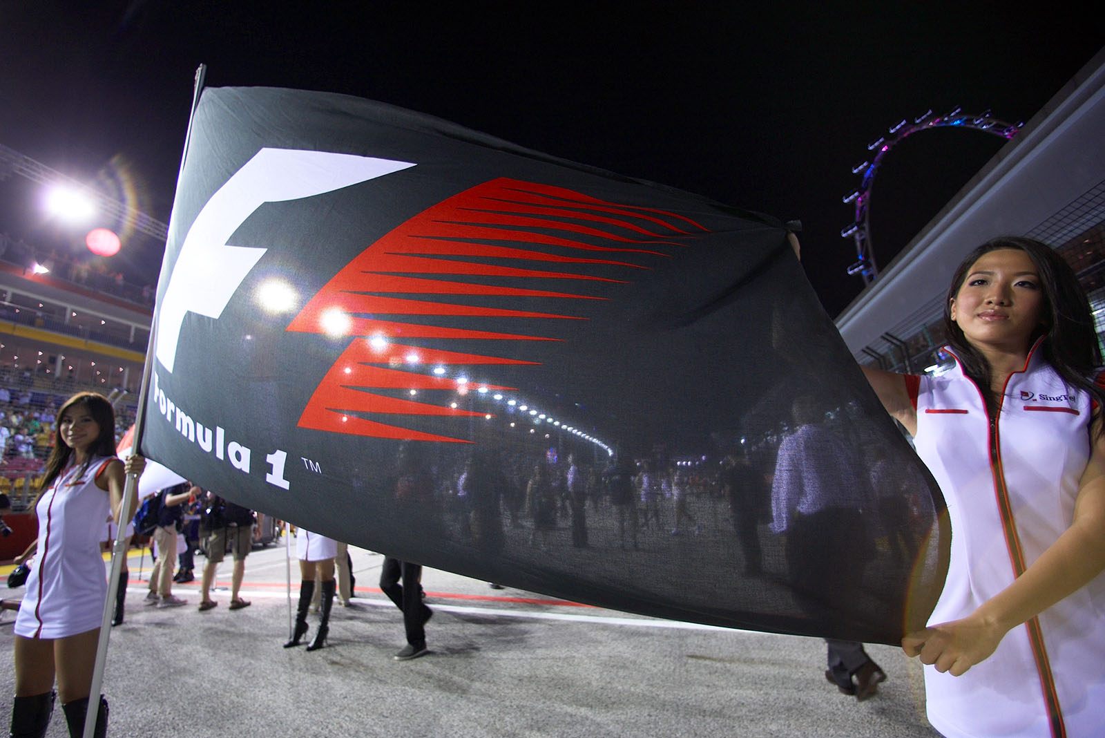Grid girls hold the Formula One banner