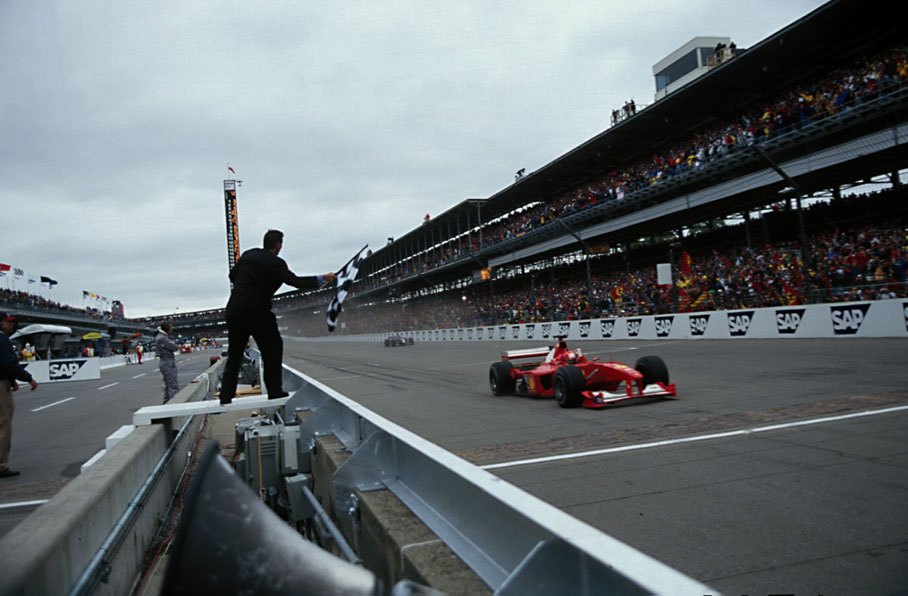 Michael Schumacher takes the chequered flag