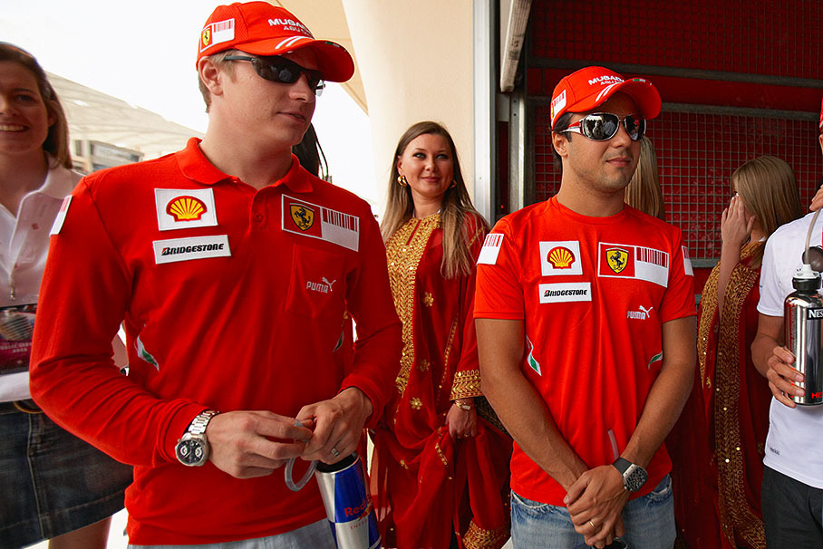 Ferrari drivers Raikkonen and Massa wait together before drivers parade