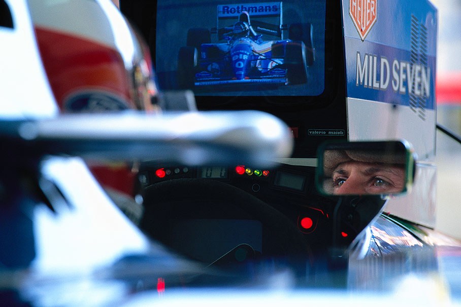 Michael Schumacher watches the qualifying performance of his competitor Damon Hill