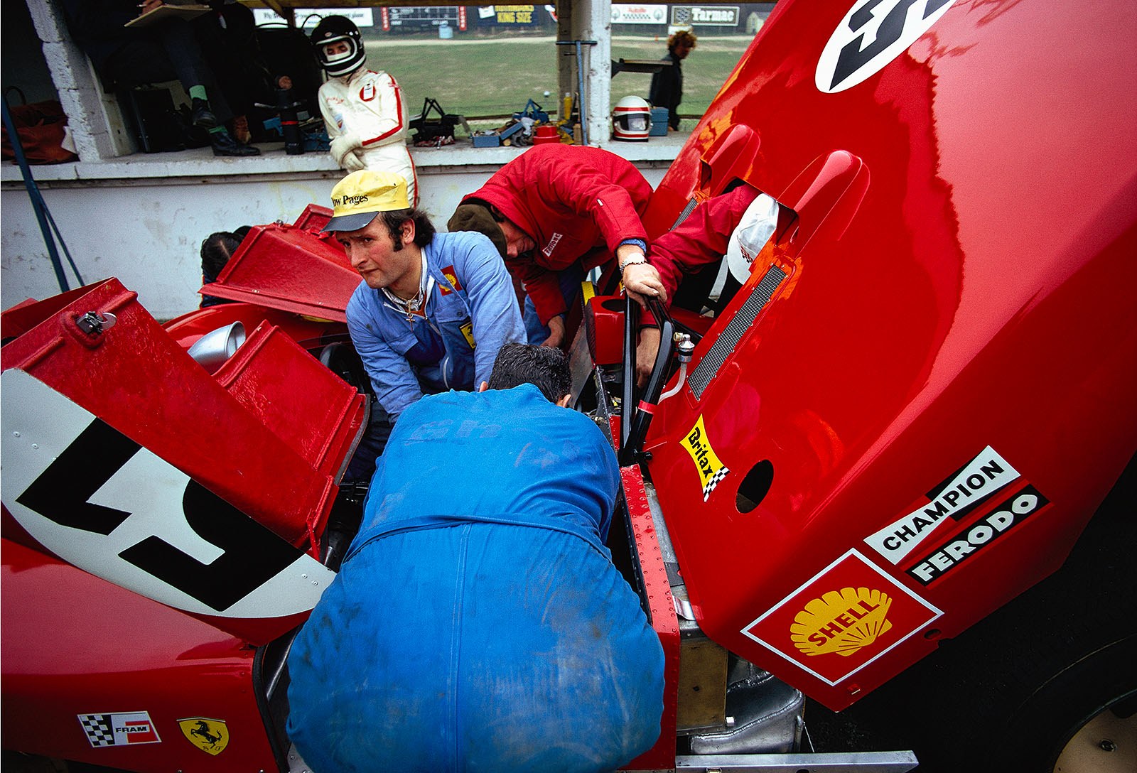 The second placed Ferrari 312 PB #0878 of Jacky Ickx (B) and Clay Regazzoni (CH) is being prepared in pits whilst Jacky Ickx waits at the pitwall
