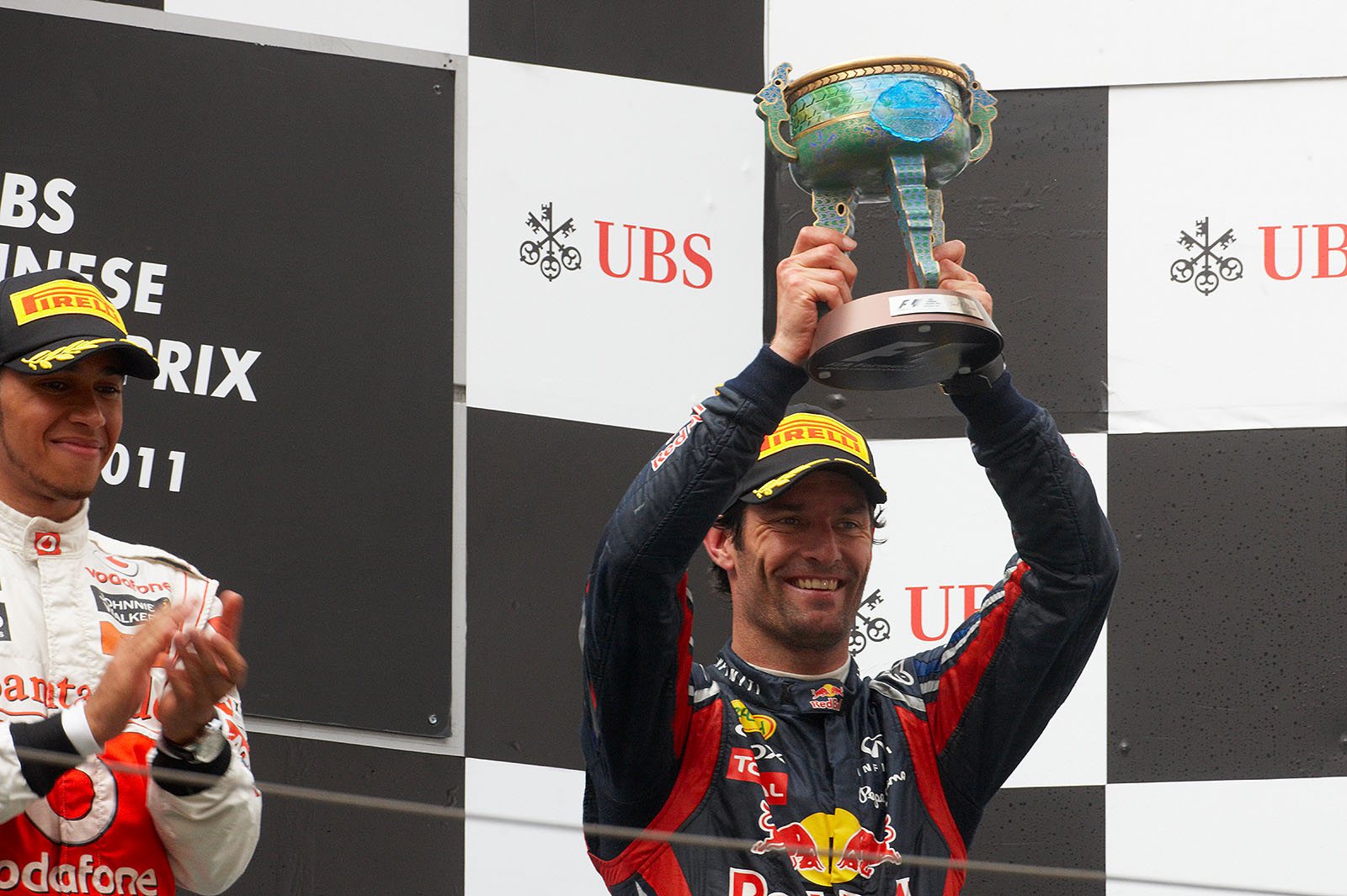 Red Bull's Mark Webber presents his trophy for third place after the Chinese GP
