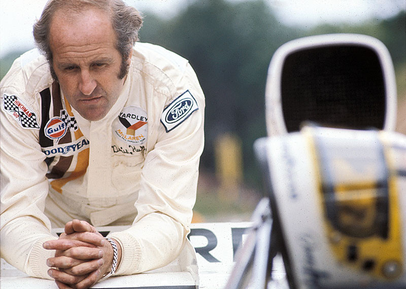 A thoughtful Denny Hulme looks at the McLaren-Cosworth M19C, French GP Clermont-Ferrand 1972
