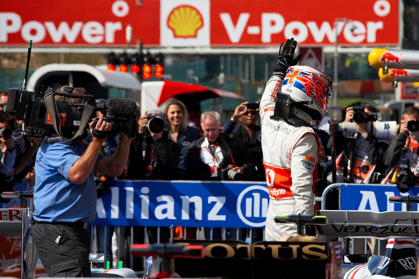 Polesetter Jenson Button of McLaren Mercedes celebrates in parc ferme after Q3
