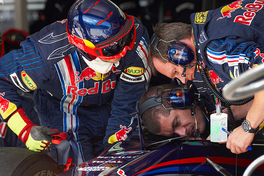 Sebastian Vettel's retired car undergoes close inspections in Red Bull pits