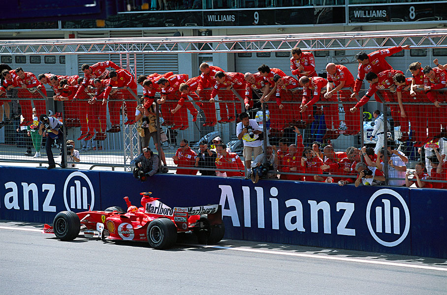 Michael Schumacher passing his cheering team