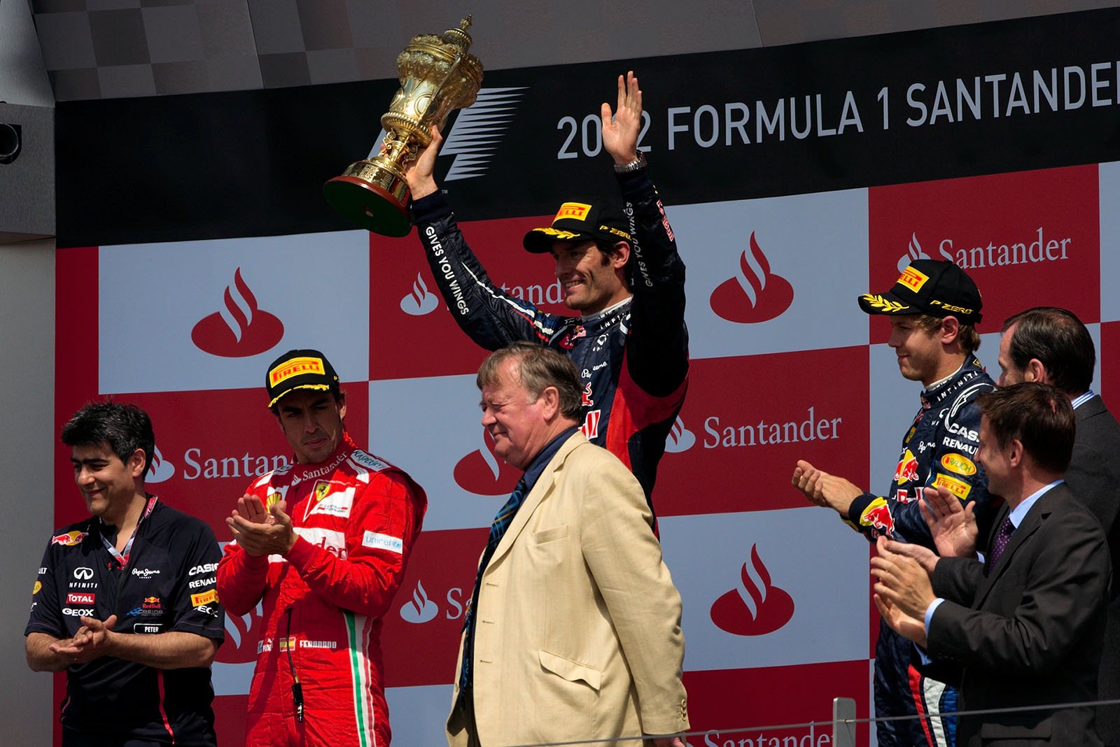 Race winner Mark Webber of Red Bull Racing presents his trophy for the winning driver