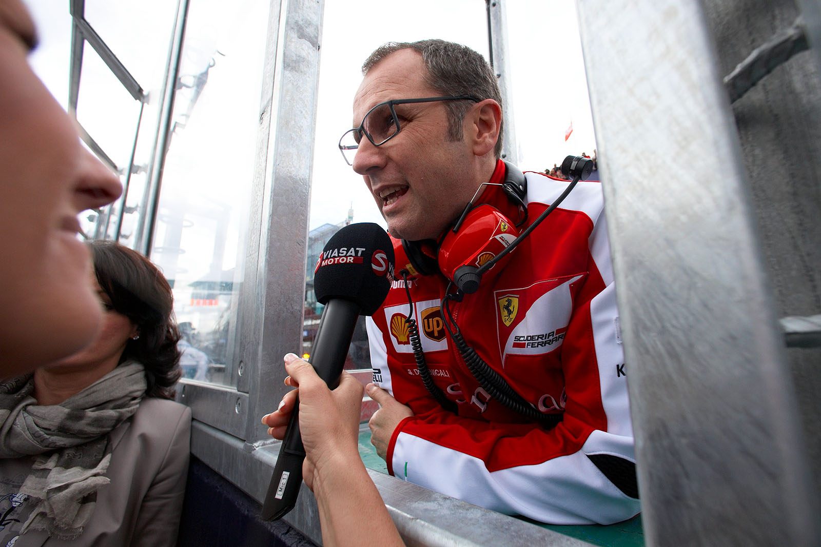Ferrari team principal Stefano Domenicali gives an interview at the pitwall