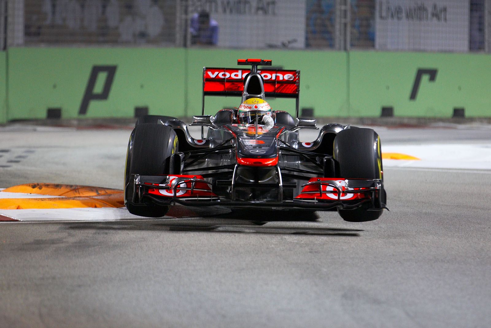 Lewis Hamilton, McLaren Mercedes, jumps over the curb