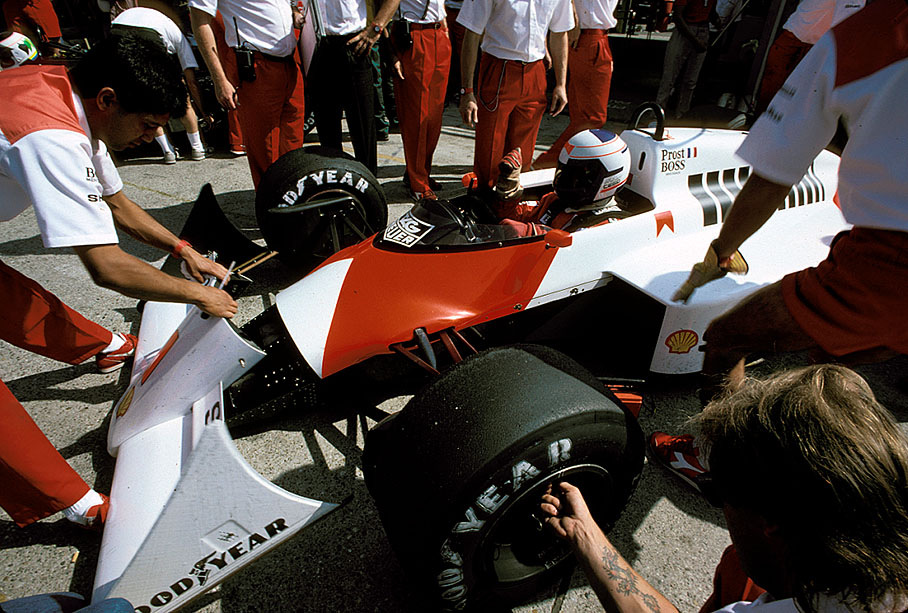 Alain Prost being serviced by his McLaren mechanics