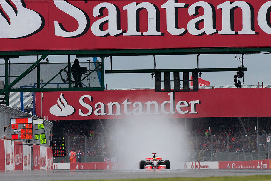 Race leader Hamilton on the long start &amp; finish straight with a cloud of spray behind him