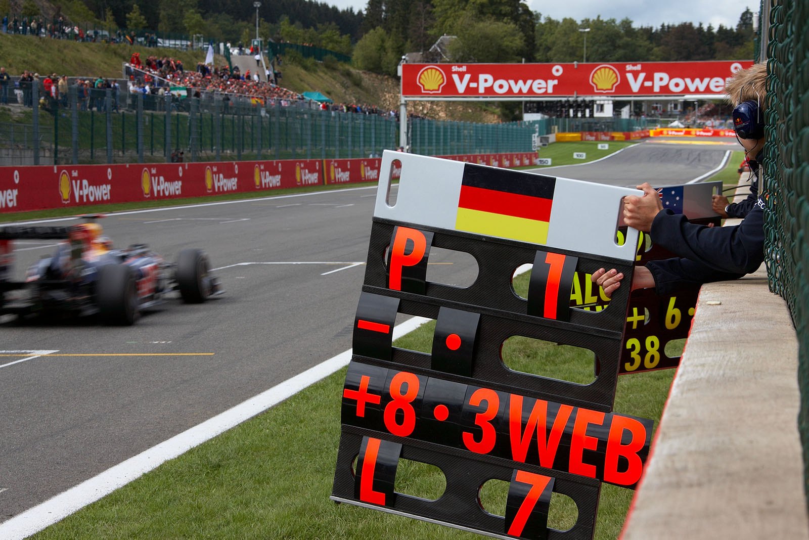 Sebastian Vettel's pit board signals first position from Red Bull Racing pit wall, with a large gap to Webber and seven laps to go
