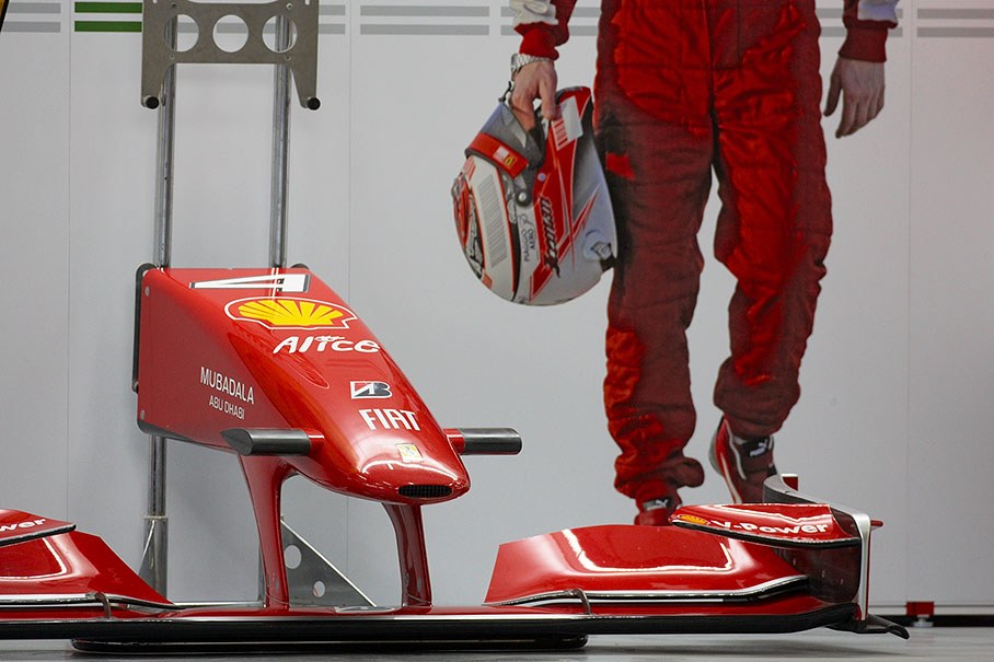 The detached front wing of a Ferrari car in pits