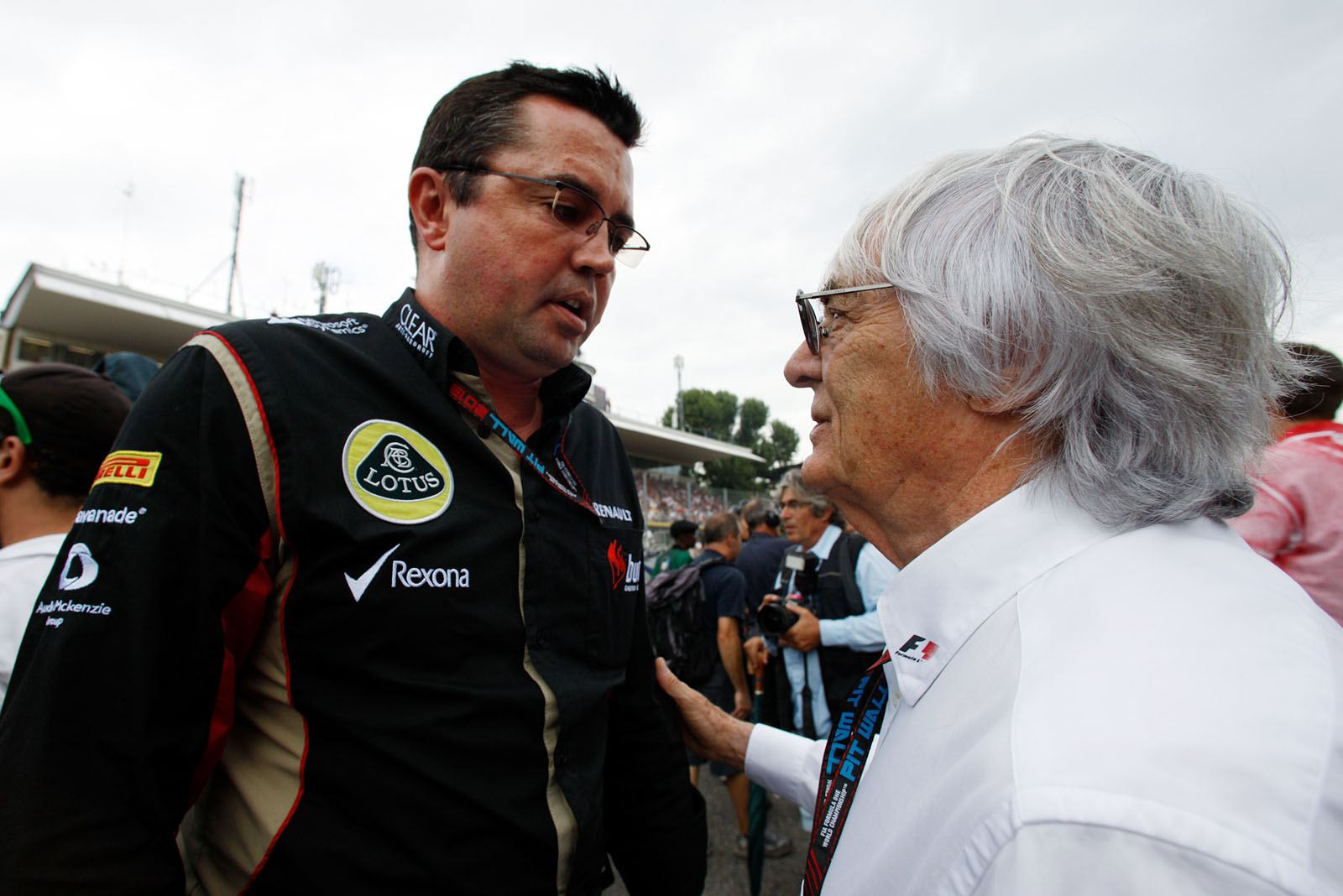 Formula One Group CEO Bernie Ecclestone chats with Lotus team principal Eric Boullier before the race