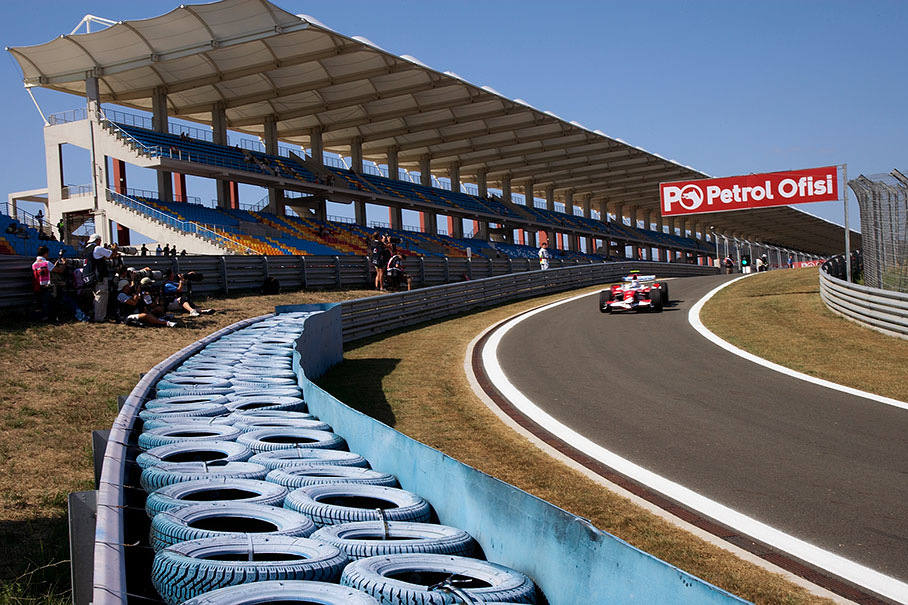 Trulli passes the photographers at pit lane exit
