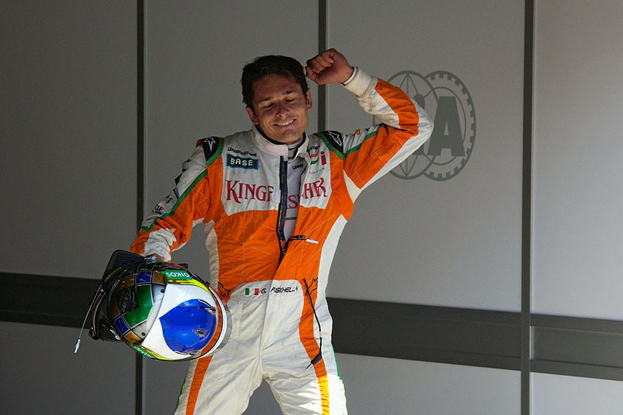 The happy polesetter Giancarlo Fisichella celebrates his unexpected achievement