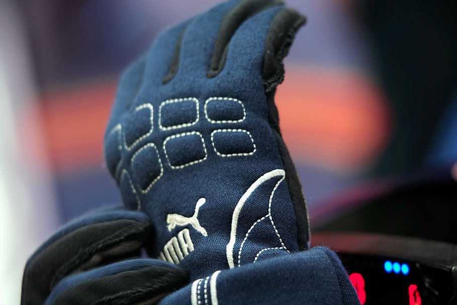 Mark Webber puts his Puma gloves on