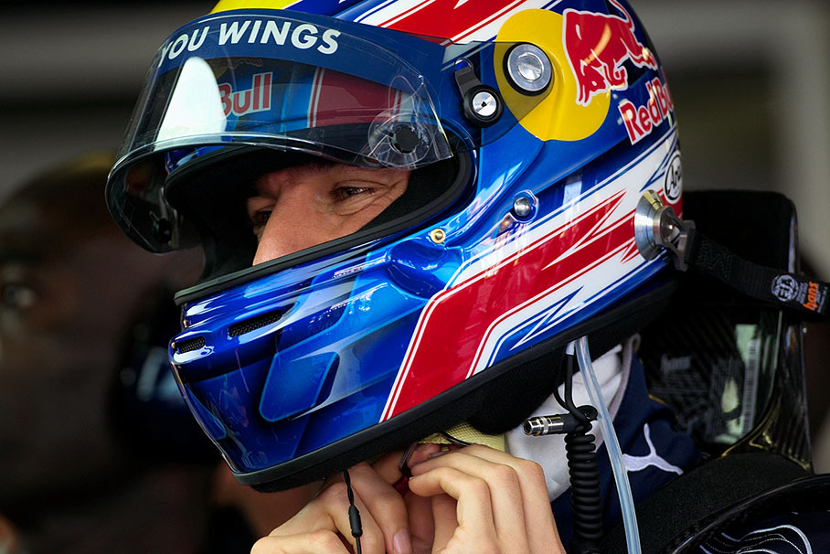 Red Bull rider Mark Webber puts his helmet on