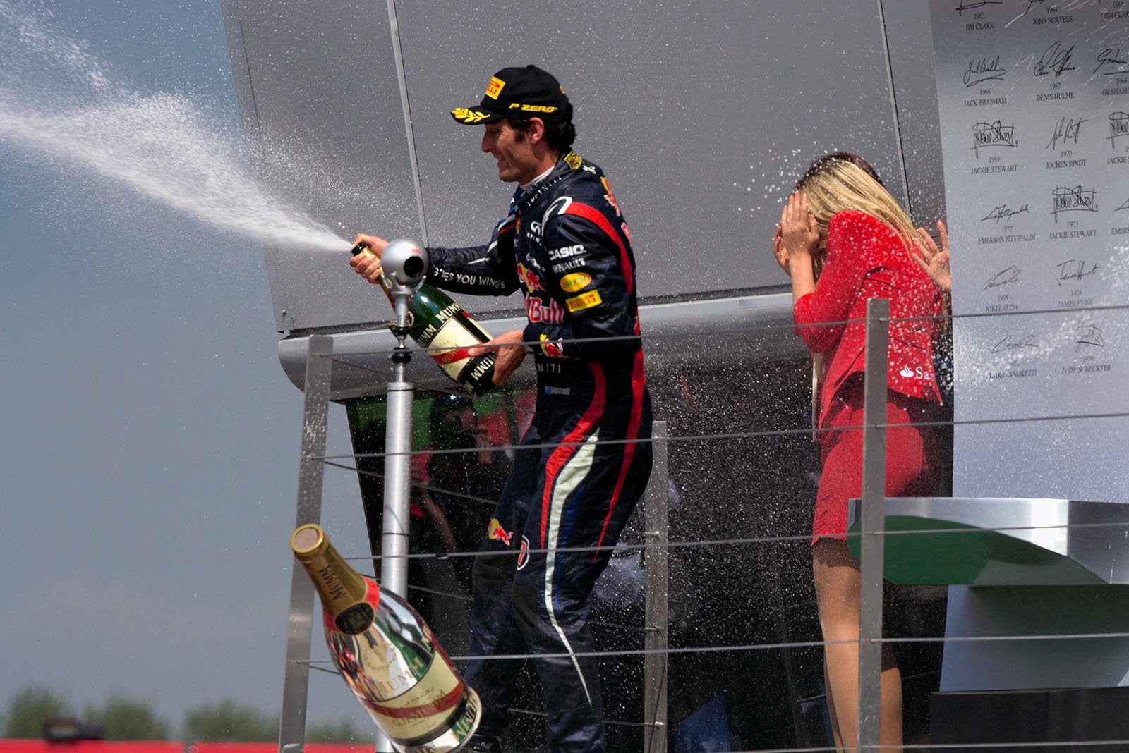 Race winner Mark Webber of Red Bull Racing sprays champagne on the podium