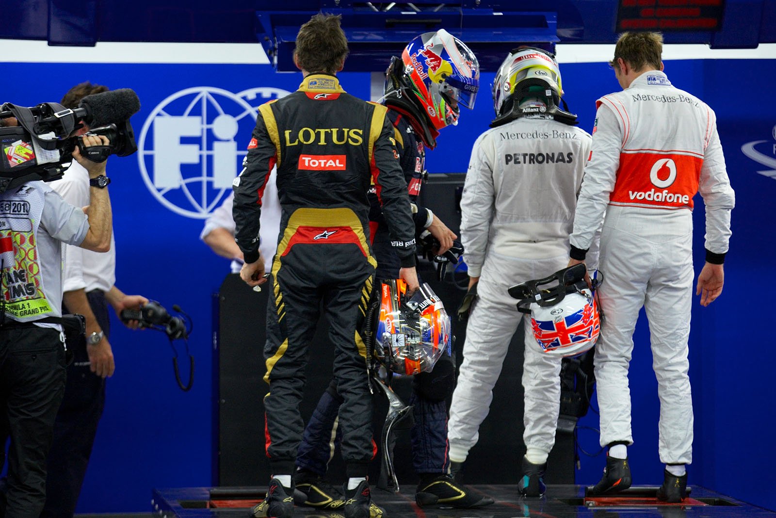 Grosjean, Ricciardo, Hamilton and Button weigh themself at FIA scrutineering after qualifying