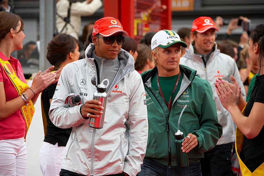 Lewis Hamilton and Heikki Kovalainen walk to drivers parade
